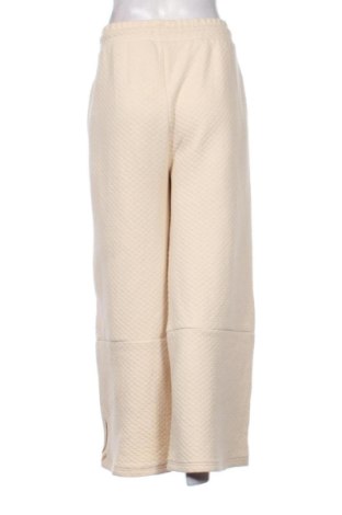 Дамско спортно долнище Karl Kani, Размер L, Цвят Екрю, Цена 27,00 €